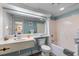 Bright bathroom featuring a large mirror, a sink, a toilet, and a shower-tub combination with grab bars at 202 74Th Ave. N # 2547/2548, Myrtle Beach, SC 29572