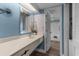 Well-lit bathroom featuring a single sink vanity with a decorative mirror and easy access to the shower and laundry at 202 74Th Ave. N # 2547/2548, Myrtle Beach, SC 29572