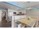 Charming kitchen with white cabinets complemented by an adjacent dining area with modern light fixture at 202 74Th Ave. N # 2547/2548, Myrtle Beach, SC 29572