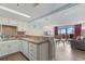 Charming kitchen with white cabinets adjoins a living space filled with natural light and balcony access at 202 74Th Ave. N # 2547/2548, Myrtle Beach, SC 29572