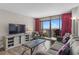 Relaxing living room with a view of the ocean through large sliding glass doors leading to a balcony at 202 74Th Ave. N # 2547/2548, Myrtle Beach, SC 29572