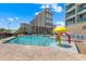 Outdoor swimming pool with lounge chairs and a colorful water play area, set against a backdrop of resort buildings at 202 74Th Ave. N # 2547/2548, Myrtle Beach, SC 29572