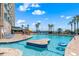 Inviting outdoor pool with a sun deck, featuring an island section in the water and palm trees for a tropical vibe at 202 74Th Ave. N # 2547/2548, Myrtle Beach, SC 29572