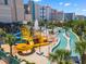 Fantastic waterpark featuring slides, fountains, and a lazy river, with palm trees and resort buildings in the background at 202 74Th Ave. N # 2547/2548, Myrtle Beach, SC 29572