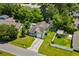 Aerial view of a charming green home with a long driveway and fenced in yard at 202 Millstone Dr., Myrtle Beach, SC 29588