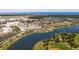 Expansive aerial view capturing the community's lake, surrounding homes, and distant ocean coastline at 202 Millstone Dr., Myrtle Beach, SC 29588