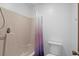 Bathroom featuring a combined shower and tub with a purple shower curtain and a modern toilet at 202 Millstone Dr., Myrtle Beach, SC 29588
