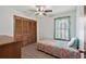 Cozy bedroom featuring a ceiling fan, wood-look floors, and built in closet space at 202 Millstone Dr., Myrtle Beach, SC 29588