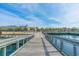 Scenic boardwalk view with palm trees lining the waterfront and views of nearby shops and restaurants at 202 Millstone Dr., Myrtle Beach, SC 29588
