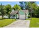 Charming home with a stone accent wall, a cozy front porch, and well-maintained landscaping at 202 Millstone Dr., Myrtle Beach, SC 29588