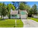 Charming home with a stone accent wall, a cozy front porch, and well-maintained landscaping at 202 Millstone Dr., Myrtle Beach, SC 29588