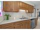 Kitchen area with wood cabinets and countertops, stainless steel sink, and modern dishwasher appliance at 202 Millstone Dr., Myrtle Beach, SC 29588