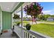 Inviting porch featuring hanging flower baskets and potted plants, creating a warm welcome at 202 Millstone Dr., Myrtle Beach, SC 29588