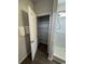 Bright bathroom showing walk in shower with wire shelving and white towels hanging on the door at 206 N Levee Dr., Georgetown, SC 29440