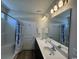 Well-lit bathroom featuring double sinks, ample counter space, a shower/tub combination, and modern fixtures at 206 N Levee Dr., Georgetown, SC 29440
