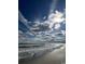 Wide sandy beach with waves and a blue sky with scattered clouds at 206 N Levee Dr., Georgetown, SC 29440