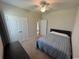 This cozy bedroom features plush carpeting, a ceiling fan, and a convenient double door closet at 206 N Levee Dr., Georgetown, SC 29440