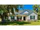 Charming single-story home with light gray siding, black shutters, well-maintained lawn, and a welcoming front porch at 206 N Levee Dr., Georgetown, SC 29440