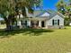 Charming single-story home with a well-maintained lawn and inviting front porch with red rocking chairs at 206 N Levee Dr., Georgetown, SC 29440