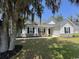 Charming single-story home with a well-maintained lawn and inviting front porch with red rocking chairs at 206 N Levee Dr., Georgetown, SC 29440