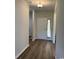 Clean hallway with wood flooring, leading to the main entrance and other rooms in the home at 206 N Levee Dr., Georgetown, SC 29440