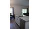 Modern kitchen island with a stainless steel sink, dishwasher, and sleek white cabinetry at 206 N Levee Dr., Georgetown, SC 29440