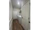 Functional laundry room with modern washer/dryer, storage shelves, and easy access to the outdoors at 206 N Levee Dr., Georgetown, SC 29440