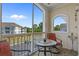 Balcony with seating area provides serene views of the surrounding community, landscaping, and clear blue skies at 2241 Waterview Dr. # 537, North Myrtle Beach, SC 29582