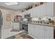 Bright kitchen boasts stainless steel appliances, granite countertops, and ample white cabinetry with a view to the front rooms at 2241 Waterview Dr. # 537, North Myrtle Beach, SC 29582