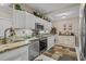 Bright kitchen features stainless steel appliances, granite countertops, and ample white cabinetry with decorative display shelving at 2241 Waterview Dr. # 537, North Myrtle Beach, SC 29582