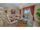Elegant living room with white couches, decorative rug, coffee table and balcony with seating and natural light at 2241 Waterview Dr. # 537, North Myrtle Beach, SC 29582