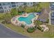 Aerial view of community pool with lounge chairs, palm trees, and building in background at 2241 Waterview Dr. # 537, North Myrtle Beach, SC 29582