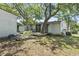 This backyard features a deck with a table and chairs, a storage shed, and mature trees at 2425 Park St., North Myrtle Beach, SC 29582