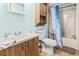 Standard bathroom with light-blue painted walls, single sink, wood cabinets, toilet, and shower-tub combination at 2425 Park St., North Myrtle Beach, SC 29582