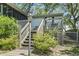 Charming home entrance with wooden steps leading to a cozy porch and lush landscaping at 2425 Park St., North Myrtle Beach, SC 29582