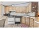 Well-equipped kitchen with wooden cabinets, sleek countertops, and essential appliances, with an adjacent dining table at 2425 Park St., North Myrtle Beach, SC 29582