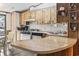 Functional kitchen with wooden cabinets, laminate countertops, and a breakfast bar, cozy dining adjacent at 2425 Park St., North Myrtle Beach, SC 29582