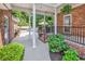 Covered back porch with columns, lush landscaping, and a view of the inviting pool area at 2441 Hunters Trail, Myrtle Beach, SC 29588