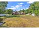 Expansive backyard featuring lush lawn, mature trees, and partial fencing, ideal for outdoor activities and privacy at 2441 Hunters Trail, Myrtle Beach, SC 29588