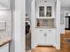 Elegant bar area with glass-front cabinets, granite countertop, and decorative backsplash at 2441 Hunters Trail, Myrtle Beach, SC 29588