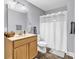 Well-lit bathroom with a single vanity, ample counter space, and a shower with white curtain at 2441 Hunters Trail, Myrtle Beach, SC 29588