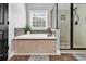 Luxurious bathroom showcases a soaking tub with decorative tile surround and a separate glass-enclosed shower for a spa-like experience at 2441 Hunters Trail, Myrtle Beach, SC 29588