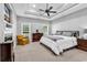 Spacious main bedroom boasts a tray ceiling, fireplace, and large windows, creating a serene and luxurious retreat at 2441 Hunters Trail, Myrtle Beach, SC 29588