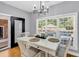 Cozy dining area with a table set for four, next to a large window offering view of the backyard pool at 2441 Hunters Trail, Myrtle Beach, SC 29588
