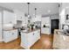 Bright kitchen features white cabinets, stainless appliances, granite countertops, and a central island with pendant lighting at 2441 Hunters Trail, Myrtle Beach, SC 29588