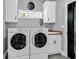 Well-equipped laundry room with modern washer and dryer, ample cabinetry, and a sink for added convenience at 2441 Hunters Trail, Myrtle Beach, SC 29588