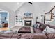 Cozy living room featuring a fireplace, built-in shelves, and a large leather sectional at 2441 Hunters Trail, Myrtle Beach, SC 29588