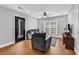 Inviting living room with hardwood floors, comfortable seating, and natural light from the window at 2441 Hunters Trail, Myrtle Beach, SC 29588
