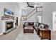 Open-concept living room with high ceilings, fireplace, and a comfortable leather sectional sofa at 2441 Hunters Trail, Myrtle Beach, SC 29588