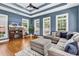 Comfortable living room with trey ceilings, large windows, and a plush sectional sofa at 2441 Hunters Trail, Myrtle Beach, SC 29588